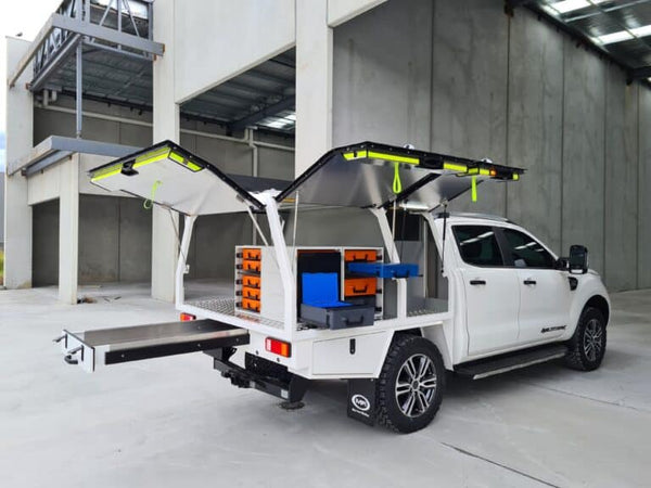 RolaCase White pickup truck with an open cargo bed in a warehouse setting
