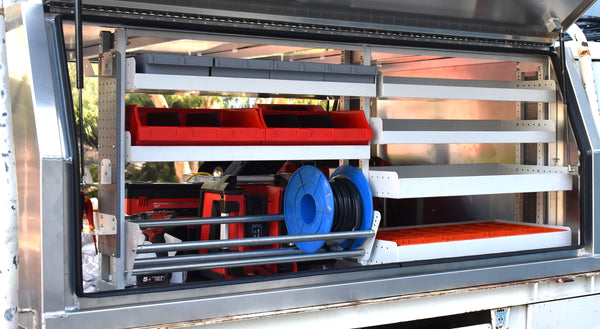 RolaShelf Metal storage cabinet with shelves and tools inside, including a red toolbox and blue hose.